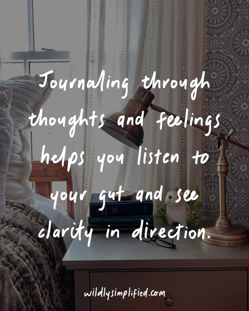 "Journaling through thoughts and feelings helps you listen to your gut and see clarity in direction." quote overlayed on a picture of a bed with a nightstand beside it